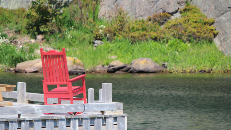 A red chair over looking the water