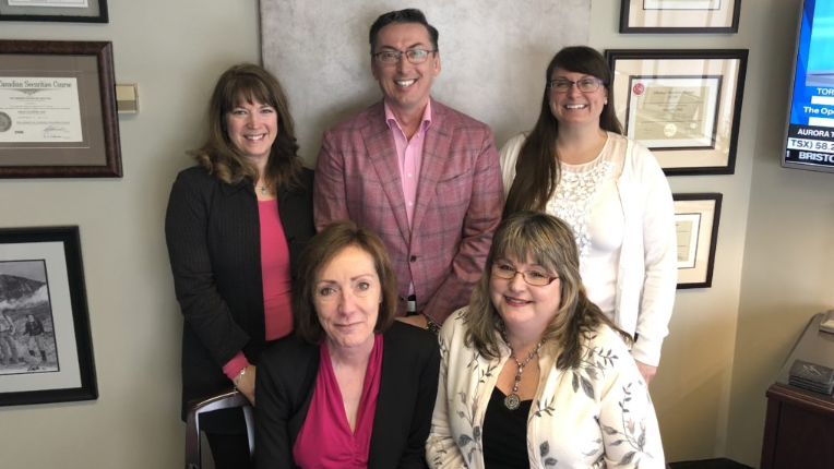 The Lee Miles Advisory Team posed with pink clothing